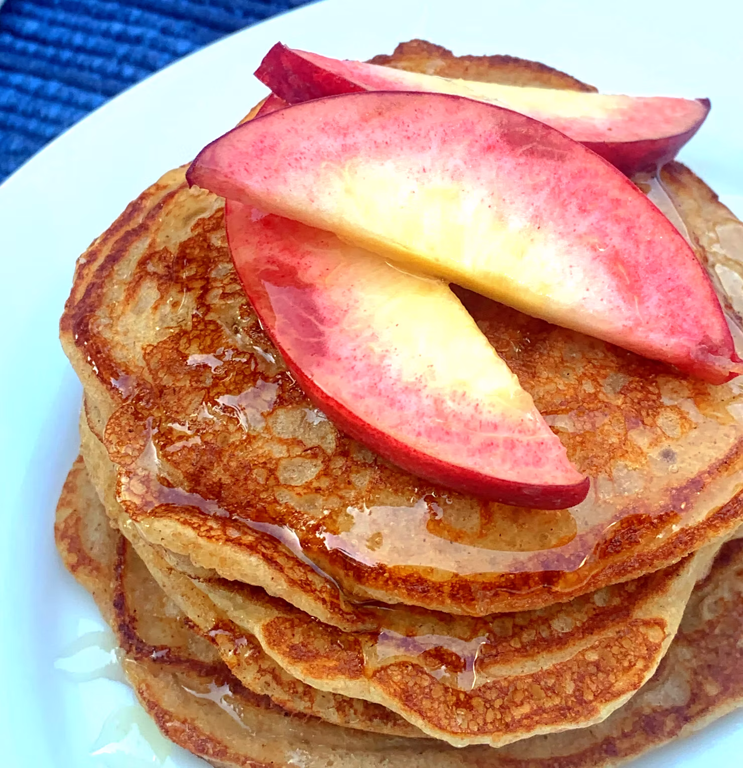 Bacon Scented Honey Whole Wheat Pancakes topped with Sliced Peaches and Honey drizzle