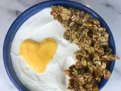 yogurt and granola in bowl with lemon curd heart