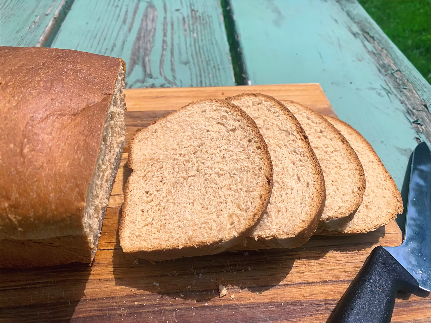 Sliced bread on a blue picnic table