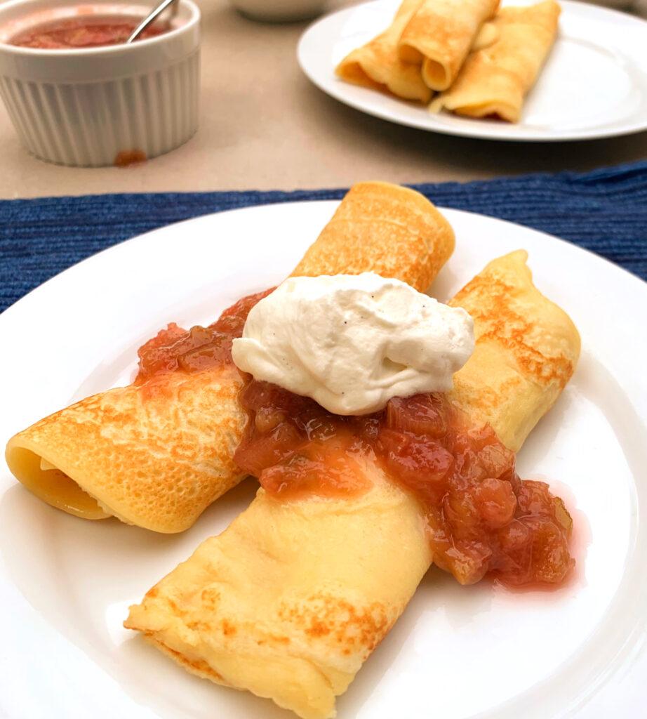 thin pancakes with rhubarb compote and whipped cream