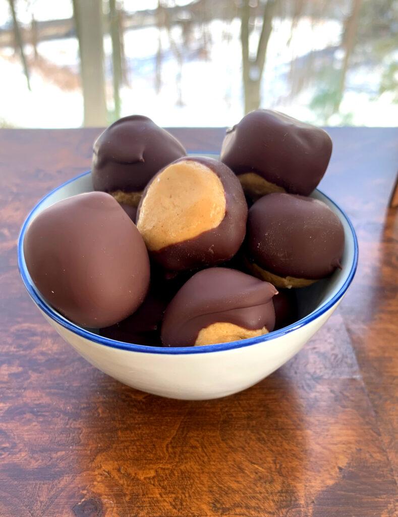 Bowl of Buckeyes in front of a window